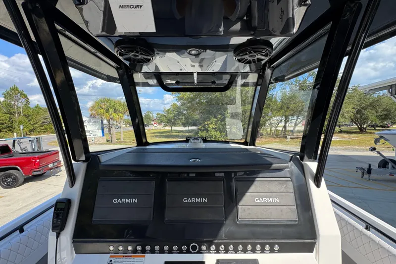 Slide: The Image of 2025 Fountain 32 NX boat dashboard with Garmin displays and Mercury controls. - 29