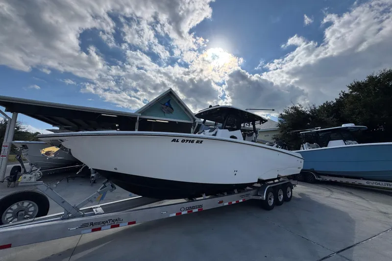 Slide: The Image of 2025 Fountain 32 NX boat on trailer under cloudy sky. - 3