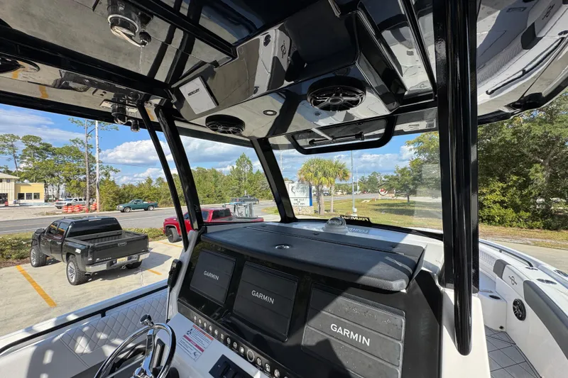 Slide: The Image of 2025 Fountain 32 NX boat interior with Garmin displays and sleek black framework. - 31