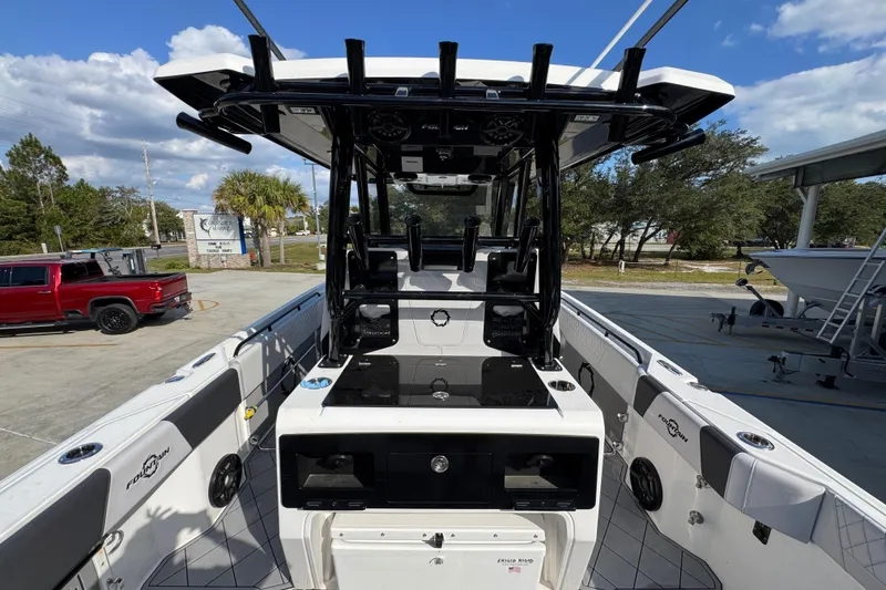 Slide: The Image of 2025 Fountain 32 NX boat interior with modern design and equipment, parked outdoors. - 33