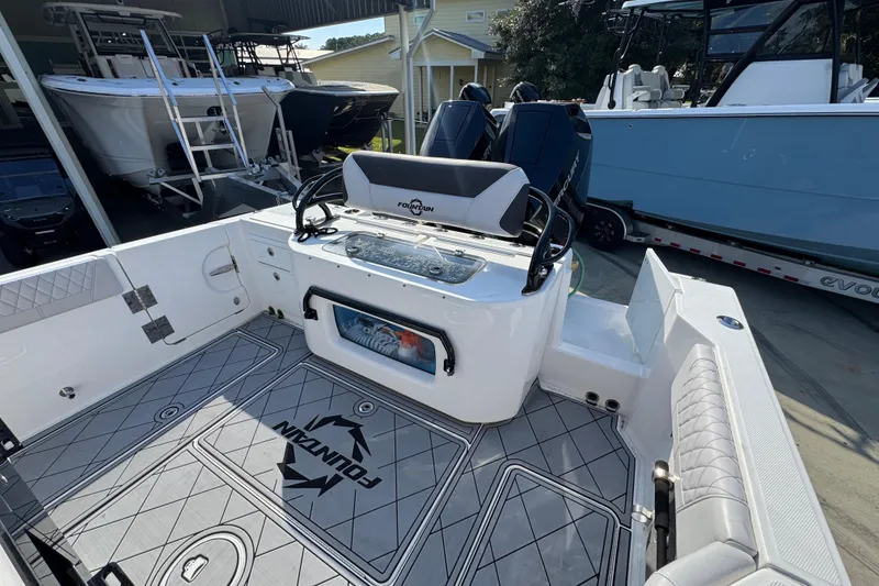 Slide: The Image of 2025 Fountain 32 NX boat interior with modern seating and storage, showcasing sleek design. - 35