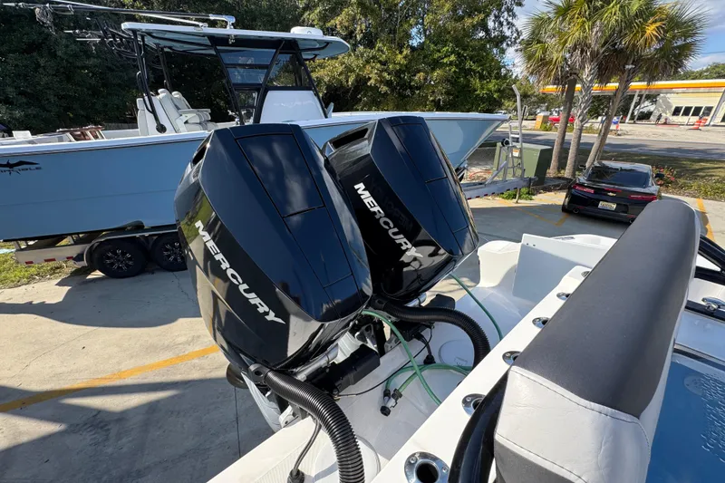 Slide: The Image of 2025 Fountain 32 NX boat with dual Mercury outboard engines, parked on a trailer. - 38