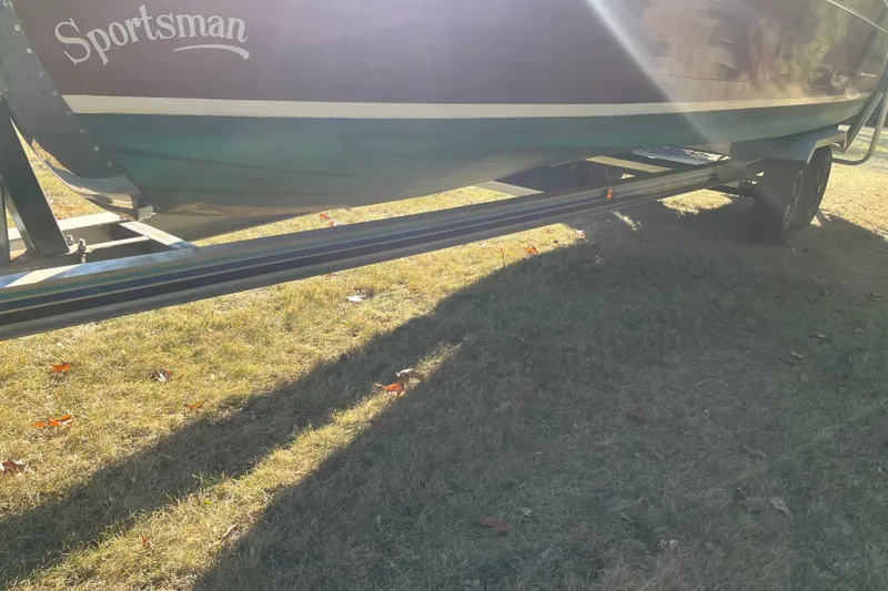 Slide: The Image of 1938 Chris-Craft 28 Sportsman boat on trailer, sunlit on grassy ground. - 10