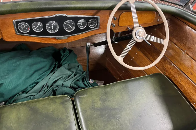 Slide: The Image of 1938 Chris-Craft 28 Sportsman boat interior with vintage steering wheel and dashboard gauges. - 20