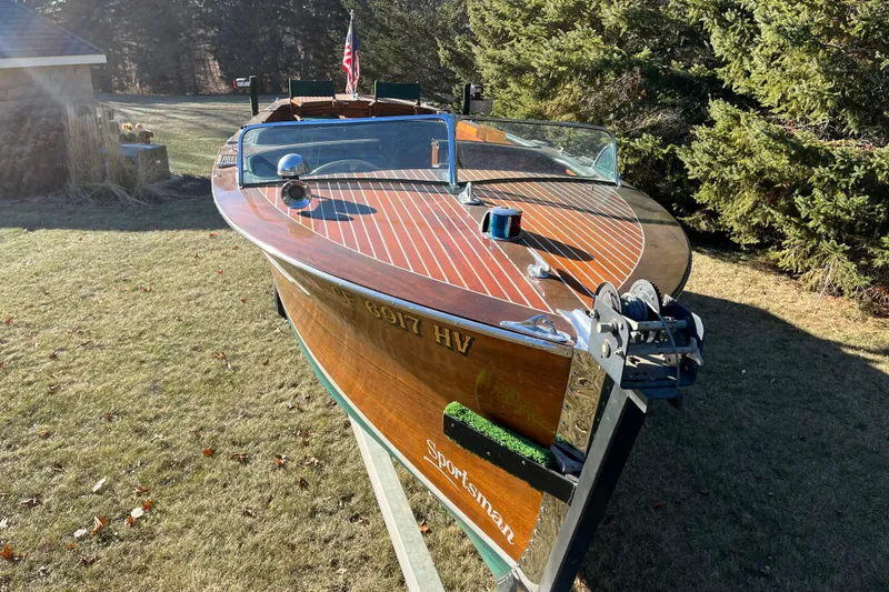 Slide: The Image of 1938 Chris-Craft 28 Sportsman boat with wooden deck, displayed outdoors. - 5