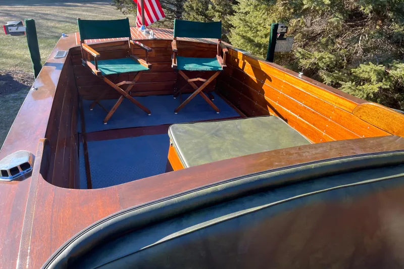 Slide: The Image of 1938 Chris-Craft 28 Sportsman boat interior with wooden finish and green chairs. - 16