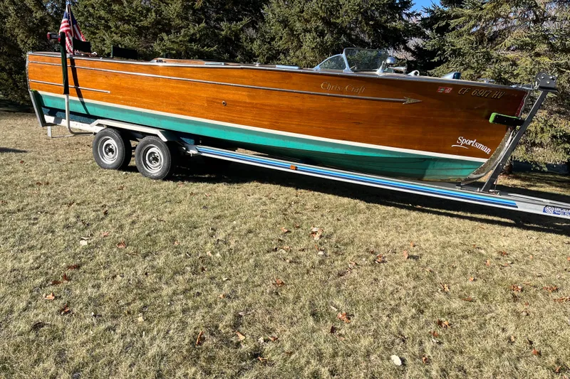 Slide: The Image of 1938 Chris-Craft 28 Sportsman boat on trailer, displayed outdoors on grass. - 6
