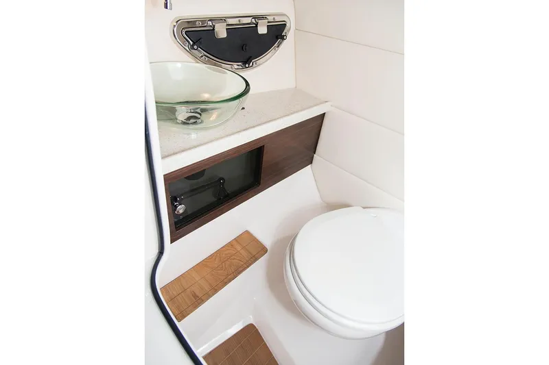 Slide: The Image of Manufacturer Provided Image: 2019 Regal 2800 Bowrider boat bathroom with modern sink and toilet. - 17