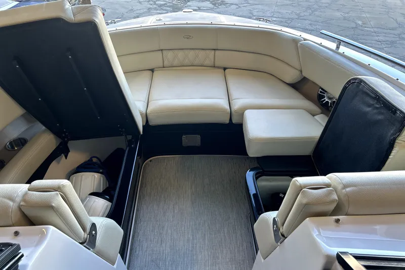 Slide: The Image of 2019 Regal 2800 Bowrider interior with beige seating and storage compartments. - 2