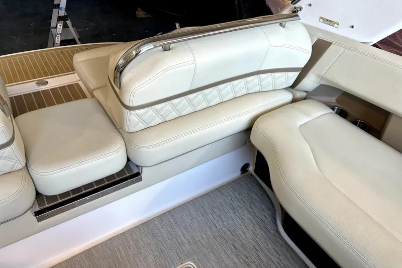 Slide: The Image of Luxurious seating on 2019 Regal 2800 Bowrider boat with beige upholstery and stainless steel accents. - 20