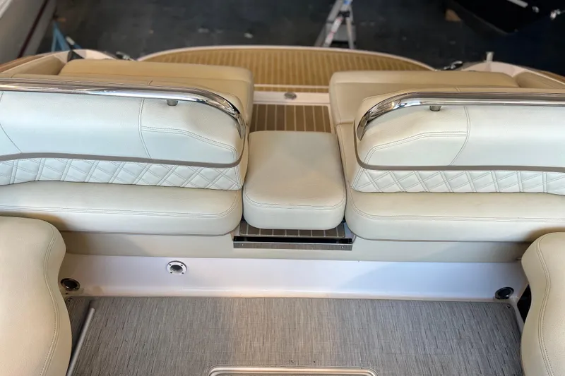 Slide: The Image of 2019 Regal 2800 Bowrider boat interior with beige leather seating and stainless steel accents. - 23