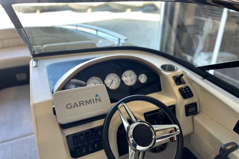Slide: The Image of 2019 Regal 2800 Bowrider dashboard with Garmin navigation system and steering wheel. - 9