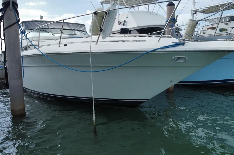 Slide: The Image of 1990 Sea Ray 420 Sundancer yacht docked in marina, side view. - 10