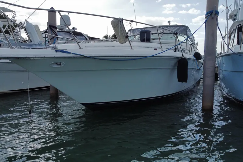 Slide: The Image of 1990 Sea Ray 420 Sundancer yacht docked in marina, side view. - 12