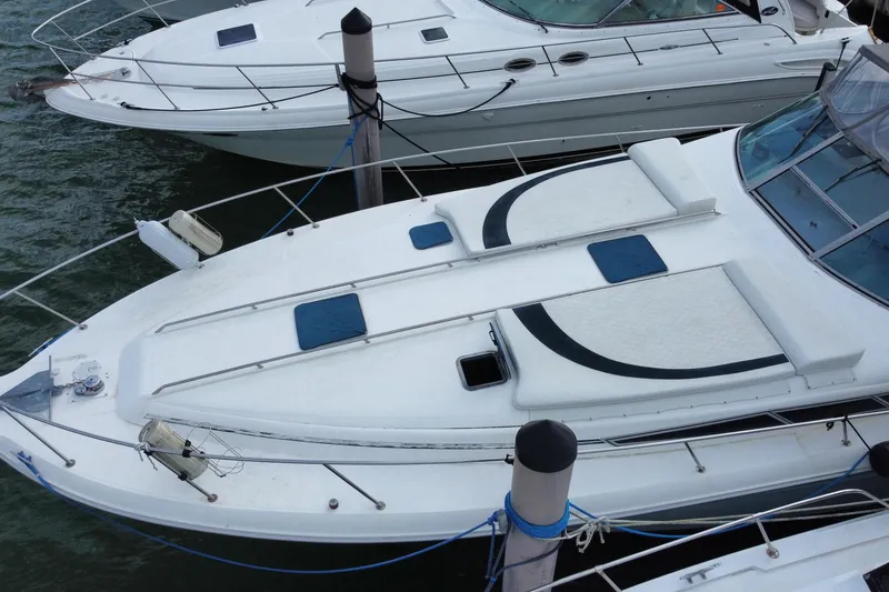 Slide: The Image of 1990 Sea Ray 420 Sundancer yacht docked, featuring sleek design and spacious deck. - 15