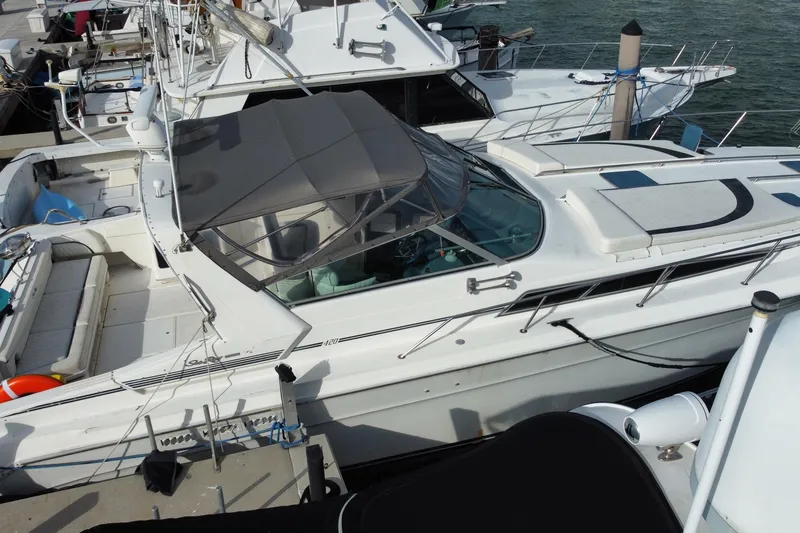 Slide: The Image of Sea Ray 420 Sundancer 1990 docked at marina, featuring sleek design and spacious deck. - 16