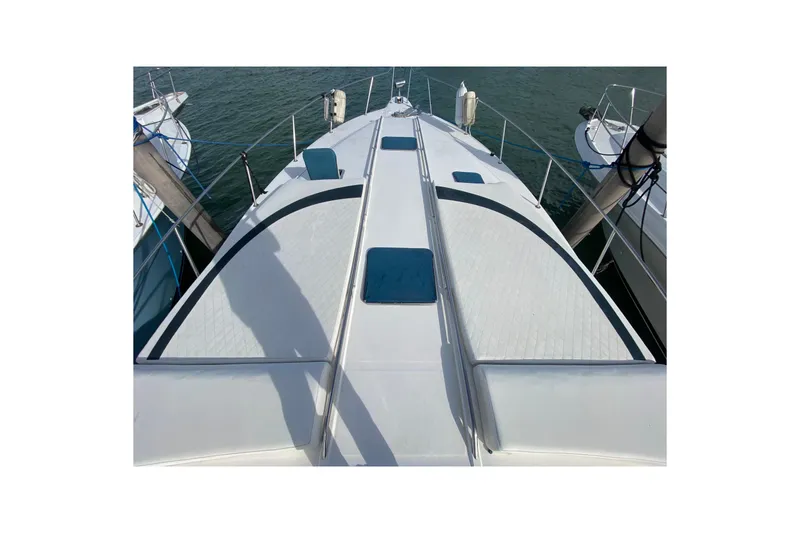 Slide: The Image of 1990 Sea Ray 420 Sundancer yacht deck, docked, with sleek design and blue accents. - 19