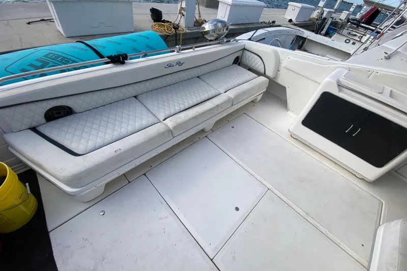 Slide: The Image of 1990 Sea Ray 420 Sundancer boat interior with white seating and storage compartments. - 26