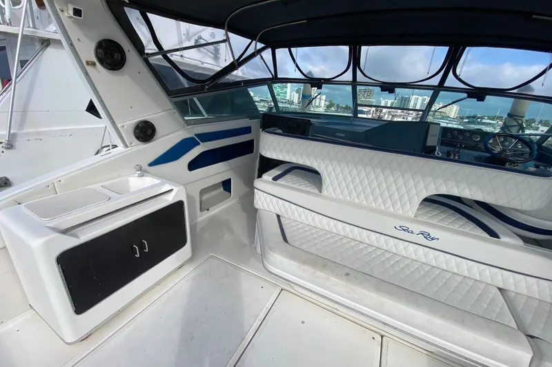 Slide: The Image of 1990 Sea Ray 420 Sundancer yacht interior with white seating and dashboard view. - 29