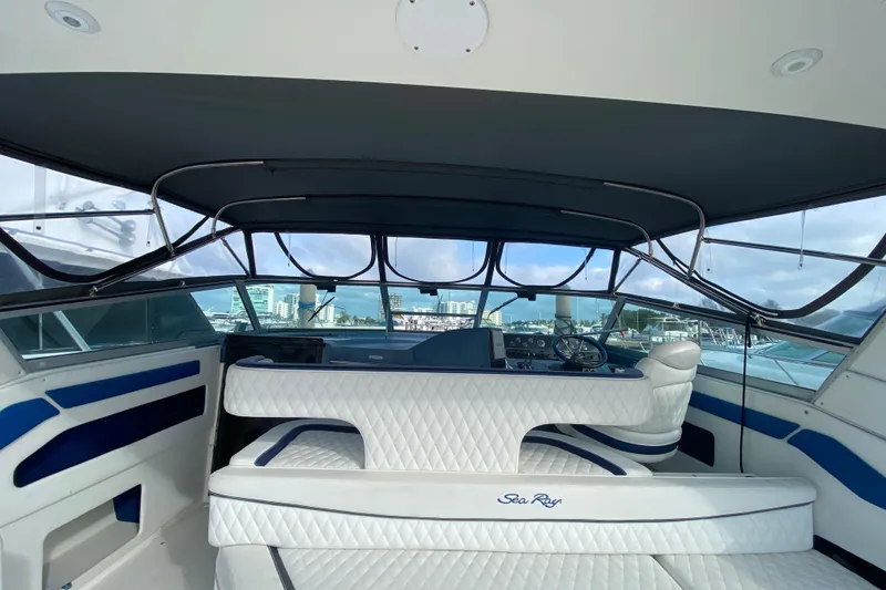 Slide: The Image of Interior view of 1990 Sea Ray 420 Sundancer yacht with white seating and helm. - 30