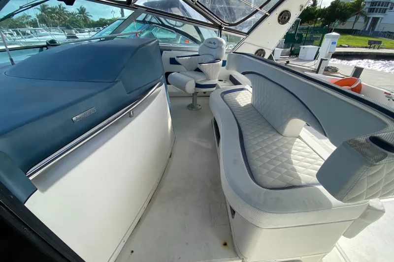 Slide: The Image of Interior of a 1990 Sea Ray 420 Sundancer yacht with blue and white seating. - 31