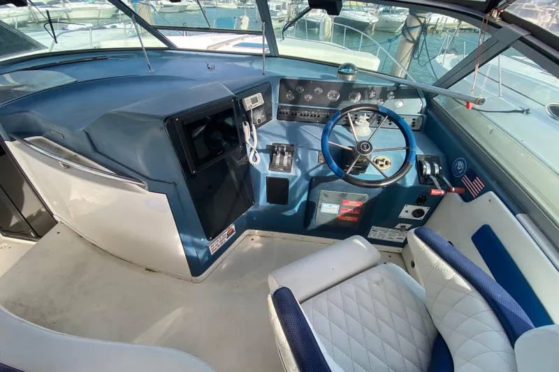Slide: The Image of Cockpit of 1990 Sea Ray 420 Sundancer with steering wheel and control panel. - 35