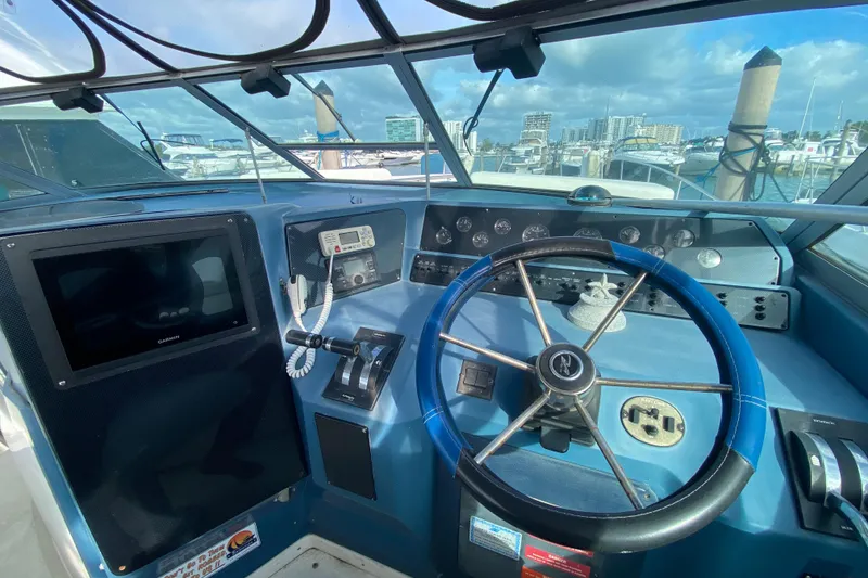 Slide: The Image of Cockpit of 1990 Sea Ray 420 Sundancer with steering wheel and navigation equipment. - 36