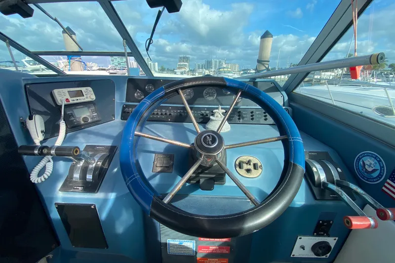 Slide: The Image of Cockpit of 1990 Sea Ray 420 Sundancer with steering wheel and control panel. - 39