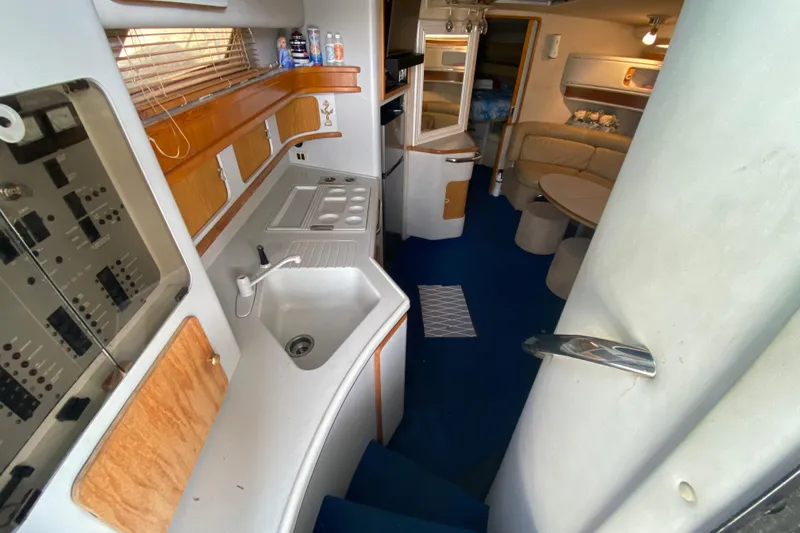 Slide: The Image of Interior of 1990 Sea Ray 420 Sundancer yacht with kitchen and seating area. - 41