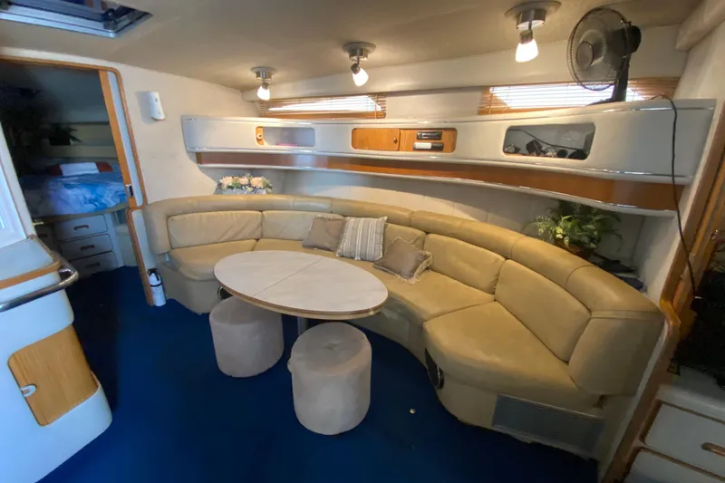 Slide: The Image of Luxurious interior of 1990 Sea Ray 420 Sundancer yacht with curved seating and table. - 43