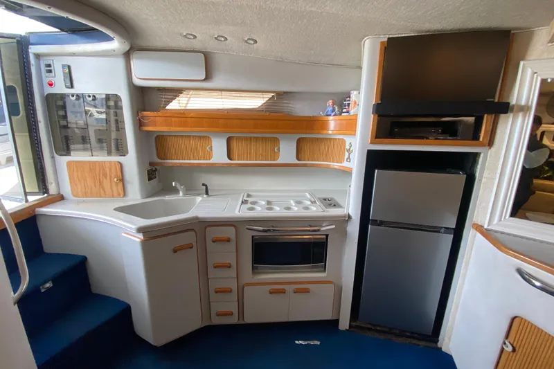 Slide: The Image of Interior of 1990 Sea Ray 420 Sundancer yacht kitchen with modern appliances. - 44