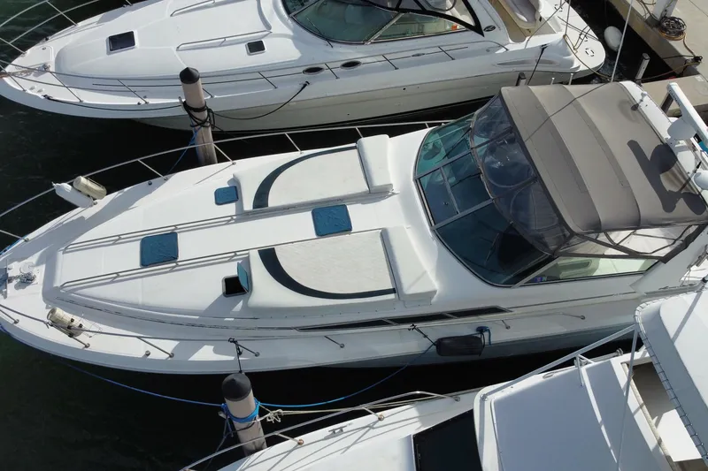 Slide: The Image of Overhead view of a 1990 Sea Ray 420 Sundancer yacht docked at a marina. - 5