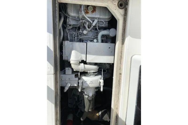 Slide: The Image of Engine compartment of a 1990 Sea Ray 420 Sundancer boat, showing mechanical components. - 52