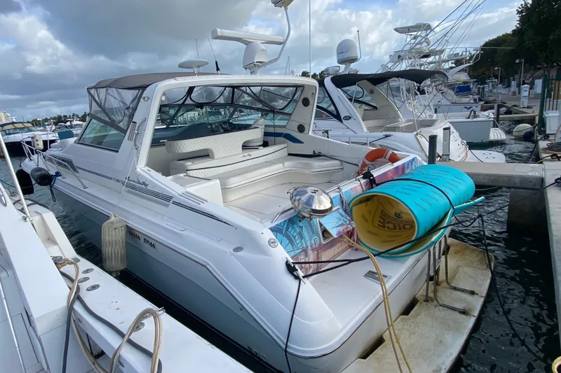 Slide: The Image of 1990 Sea Ray 420 Sundancer yacht docked at marina with water sports gear. - 55
