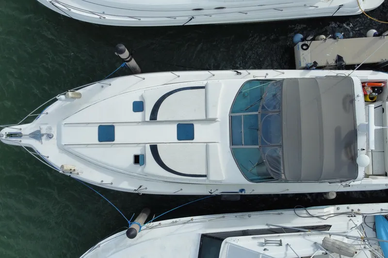 Slide: The Image of Overhead view of a 1990 Sea Ray 420 Sundancer yacht docked at a marina. - 58