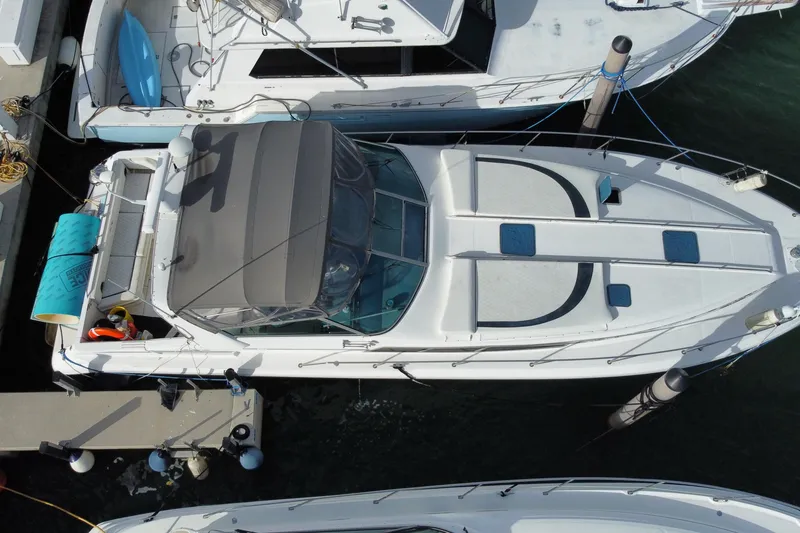Slide: The Image of Aerial view of a 1990 Sea Ray 420 Sundancer docked at a marina. - 59