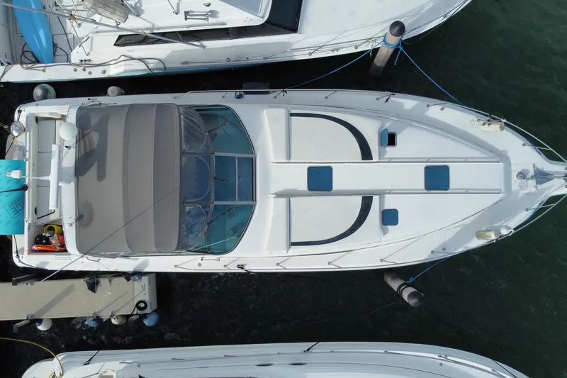 Slide: The Image of Overhead view of a 1990 Sea Ray 420 Sundancer docked at a marina. - 60