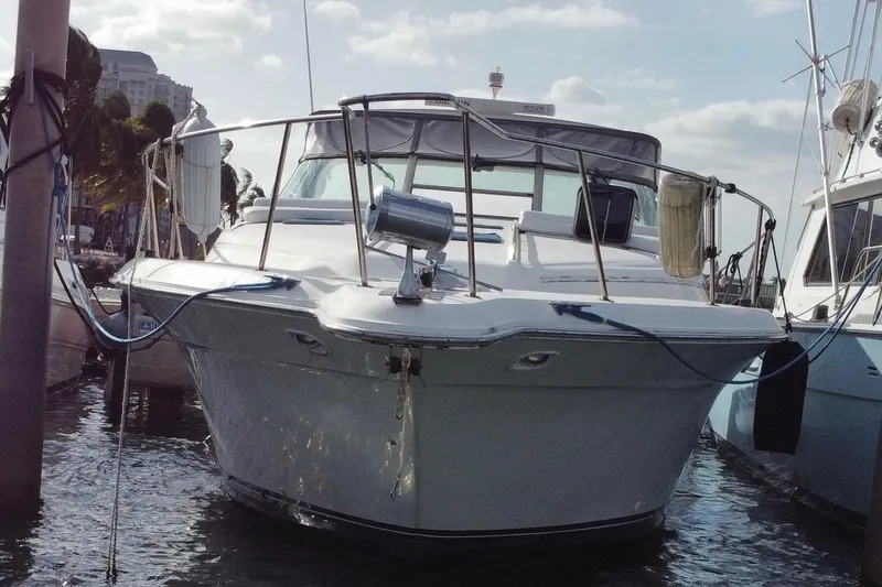 Slide: The Image of 1990 Sea Ray 420 Sundancer yacht docked at marina, front view. - 8