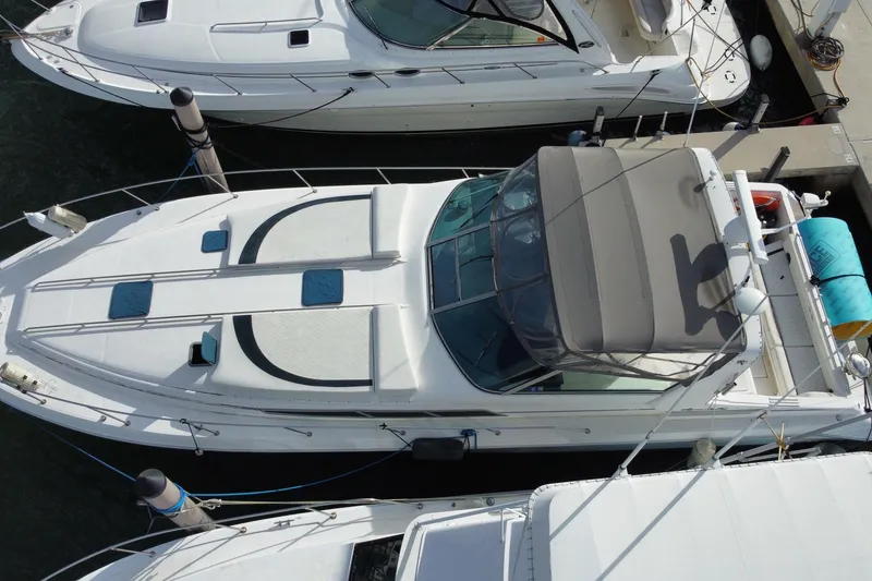 Slide: The Image of Overhead view of a 1990 Sea Ray 420 Sundancer docked at a marina. - 9
