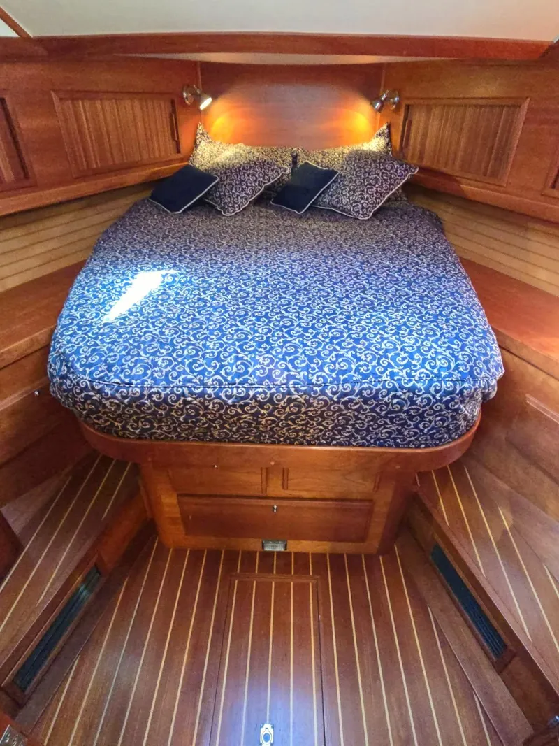 Slide: The Image of 2004 Sabre 36 Flybridge Fast Trawler cabin with elegant wood finish and cozy bedding. - 25