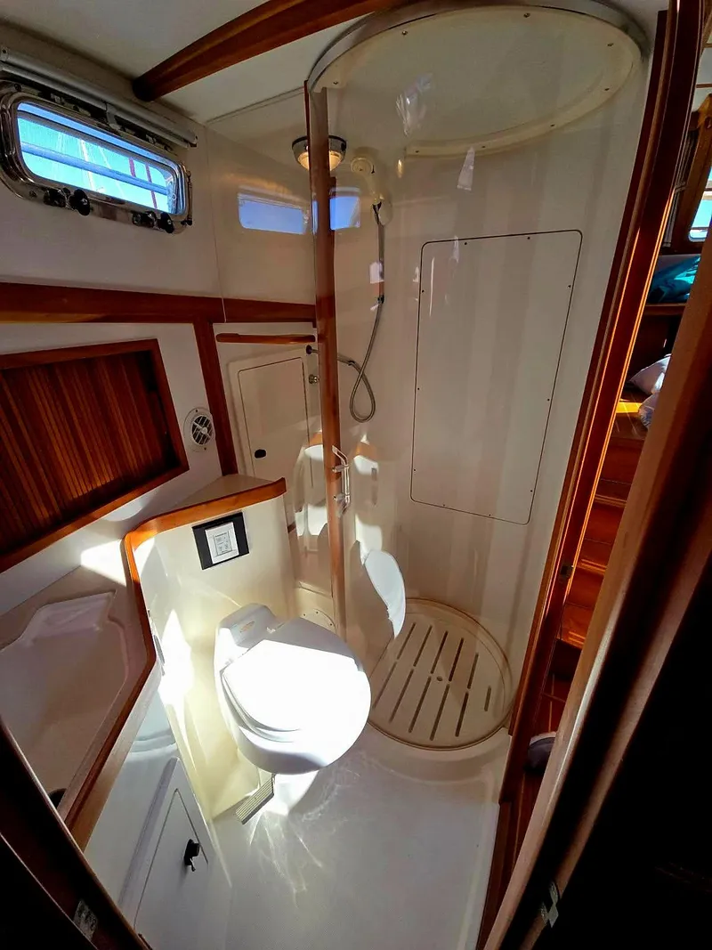 Slide: The Image of 2004 Sabre 36 Flybridge Fast Trawler bathroom with shower and wooden accents. - 32