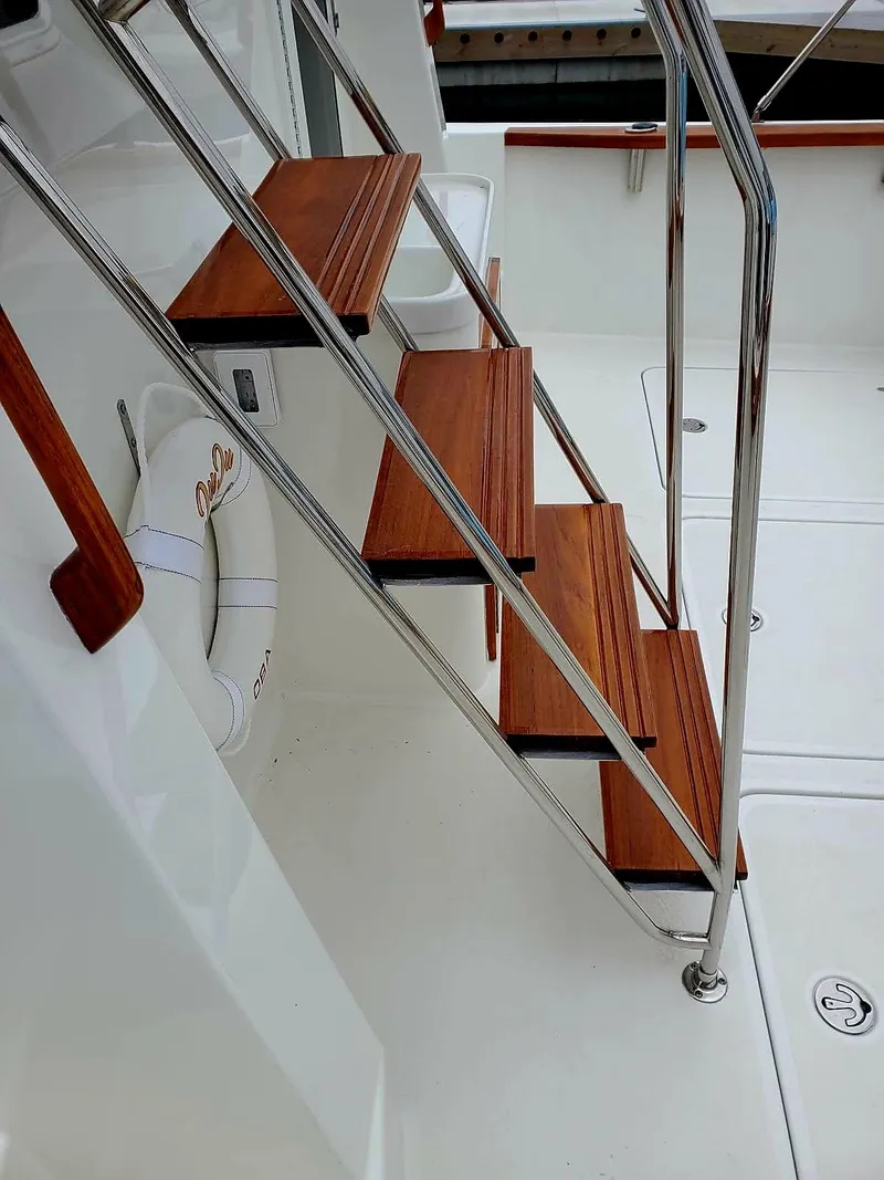 Slide: The Image of Staircase on 2004 Sabre 36 Flybridge Fast Trawler with wooden steps and metal railing. - 35