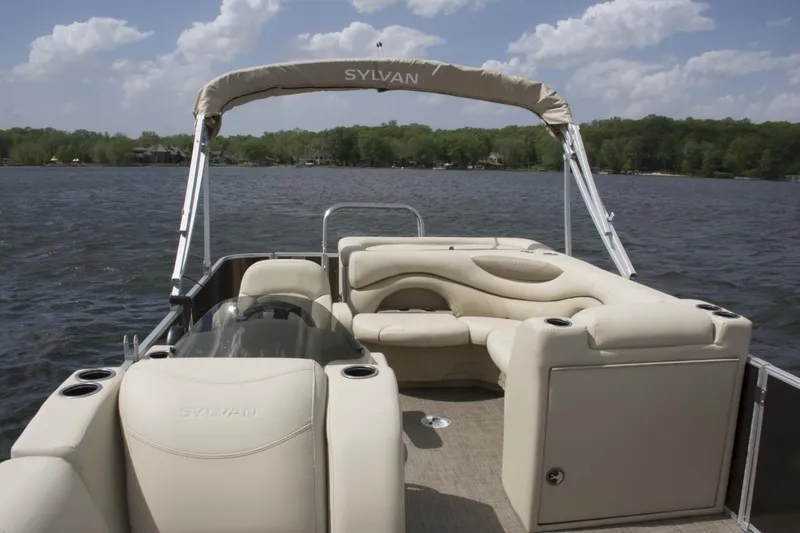 Slide: The Image of 2026 Sylvan Mirage 820 Cruise interior with beige seating and modern design. - 2