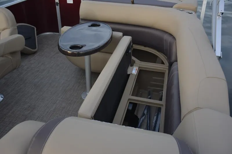 Slide: The Image of 2026 Sylvan Mirage 820 Cruise interior with storage compartment and seating area. - 7