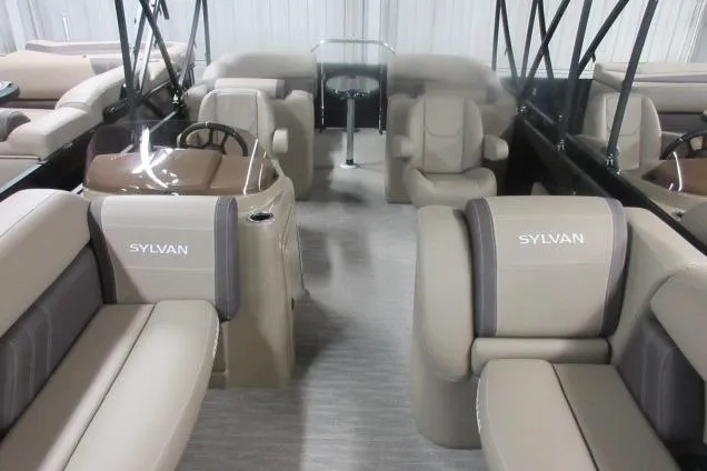 Slide: The Image of 2026 Sylvan Mirage Cruise 822 LZ interior with beige seating and modern design. - 3