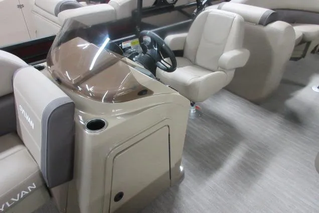 Slide: The Image of 2026 Sylvan Mirage Cruise 822 LZ interior with steering console and seating. - 4