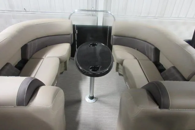 Slide: The Image of 2026 Sylvan Mirage Cruise 822 LZ interior with beige seating and central table. - 7