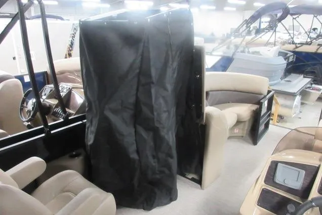 Slide: The Image of 2026 Sylvan Mirage Cruise 822 LZ interior with seating and privacy curtain. - 8