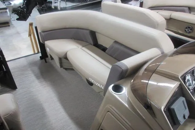 Slide: The Image of 2026 Sylvan Mirage Cruise 822 LZ interior with beige seating and modern design. - 9