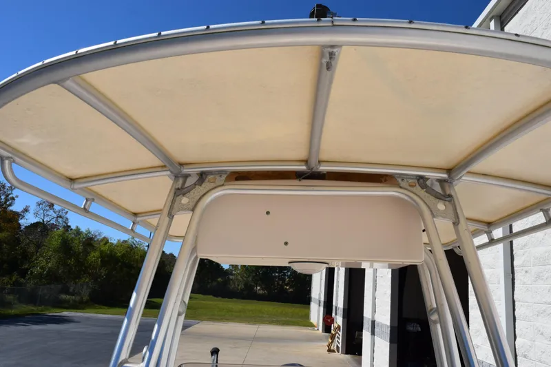 Slide: The Image of 2010 Grady-White Fisherman 209 T-top structure under clear blue sky. - 13